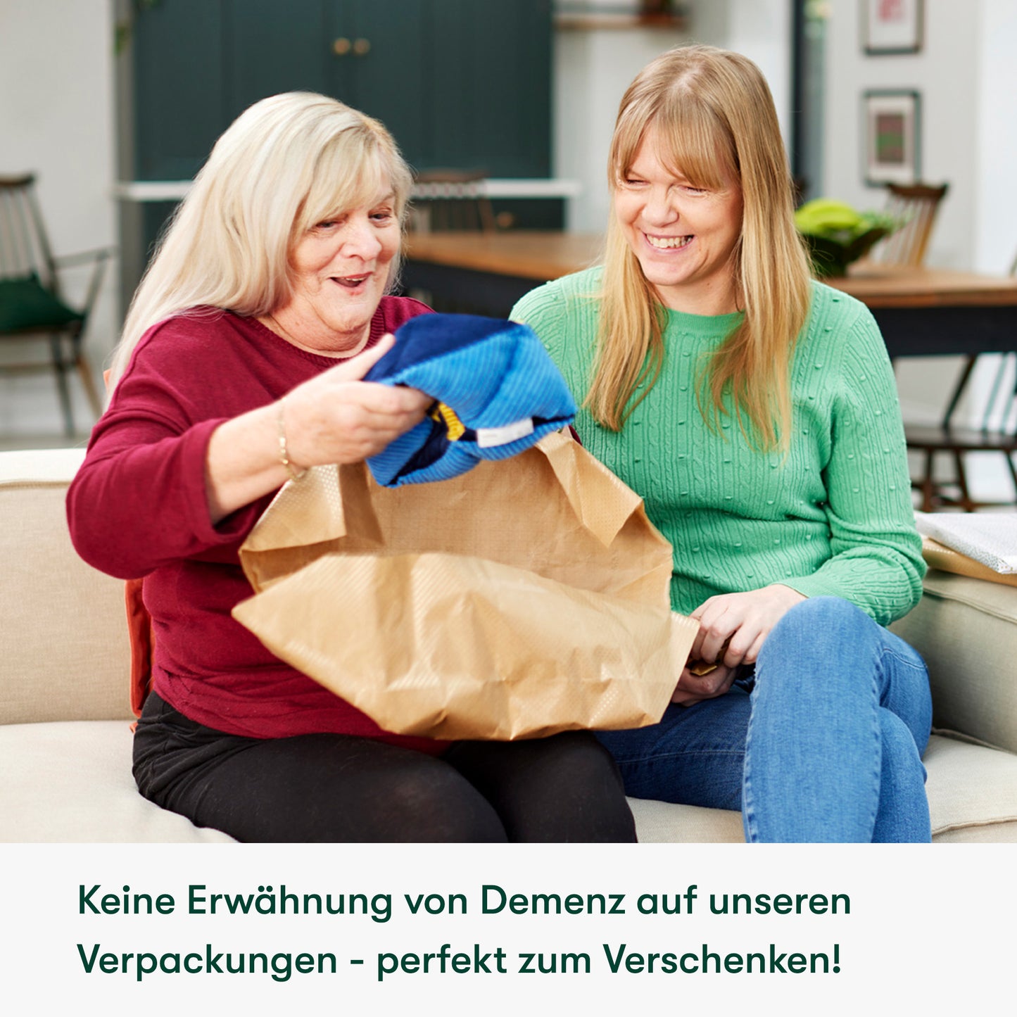 Elderly woman joyfully unwraps dementia gifts, ideal for care home activities, fostering connection and engagement.|market_de