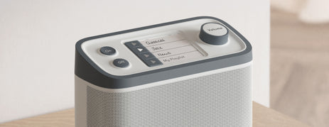 Dementia radio on a table, designed for ease of use, minimizing confusion, and promoting independence for dementia care.