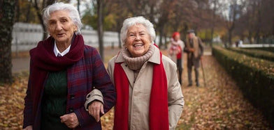 Two senior women with dementia are on a day out at the park and smiling.