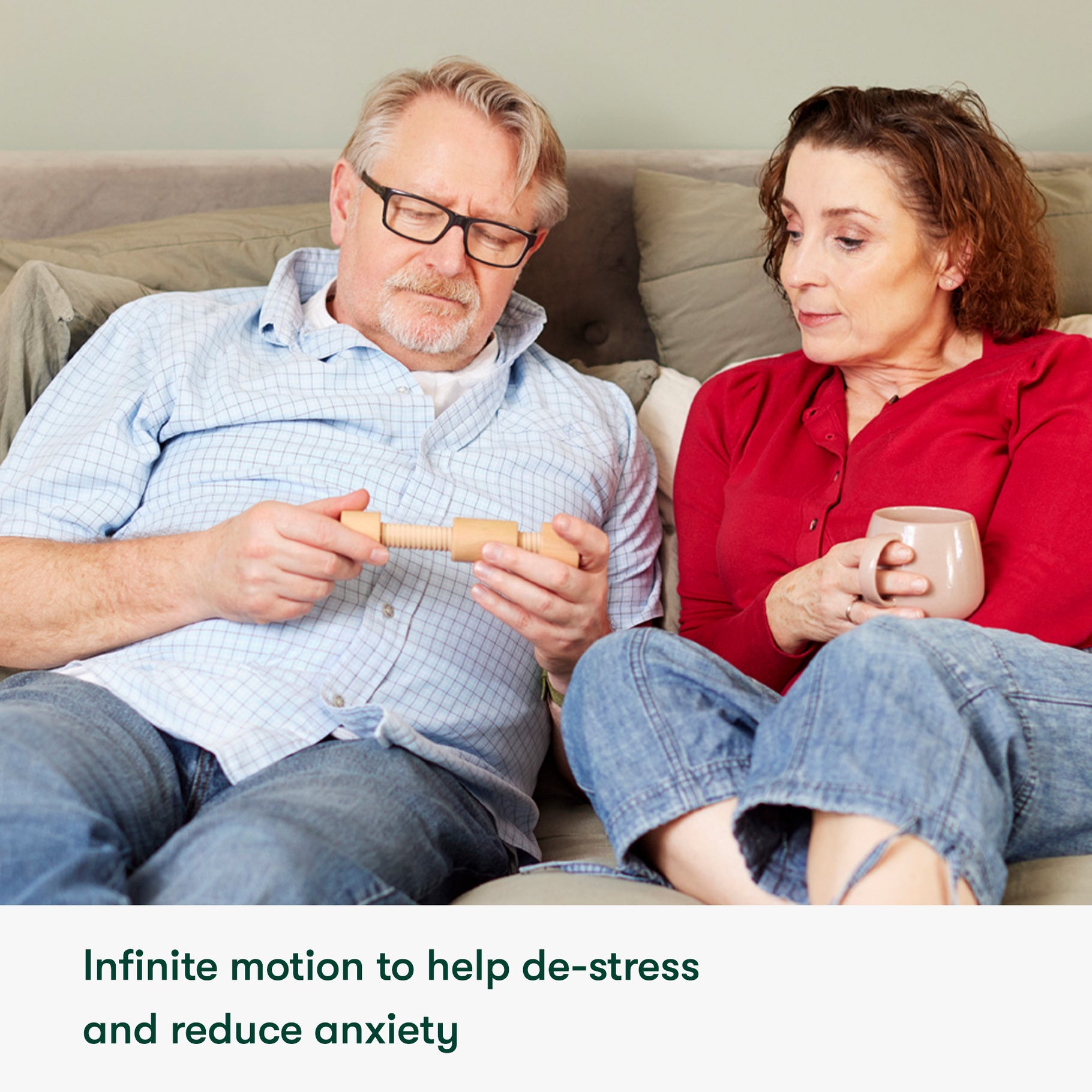 Elderly couple using a fidget toy, ideal for dementia activities, care home activities, and gifts for people living with dementia.