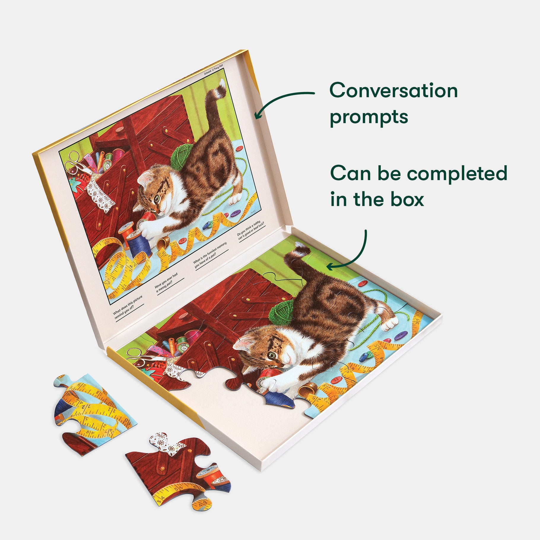 Puzzle with a cat illustration in an open box, featuring conversation prompts, designed for dementia engagement.