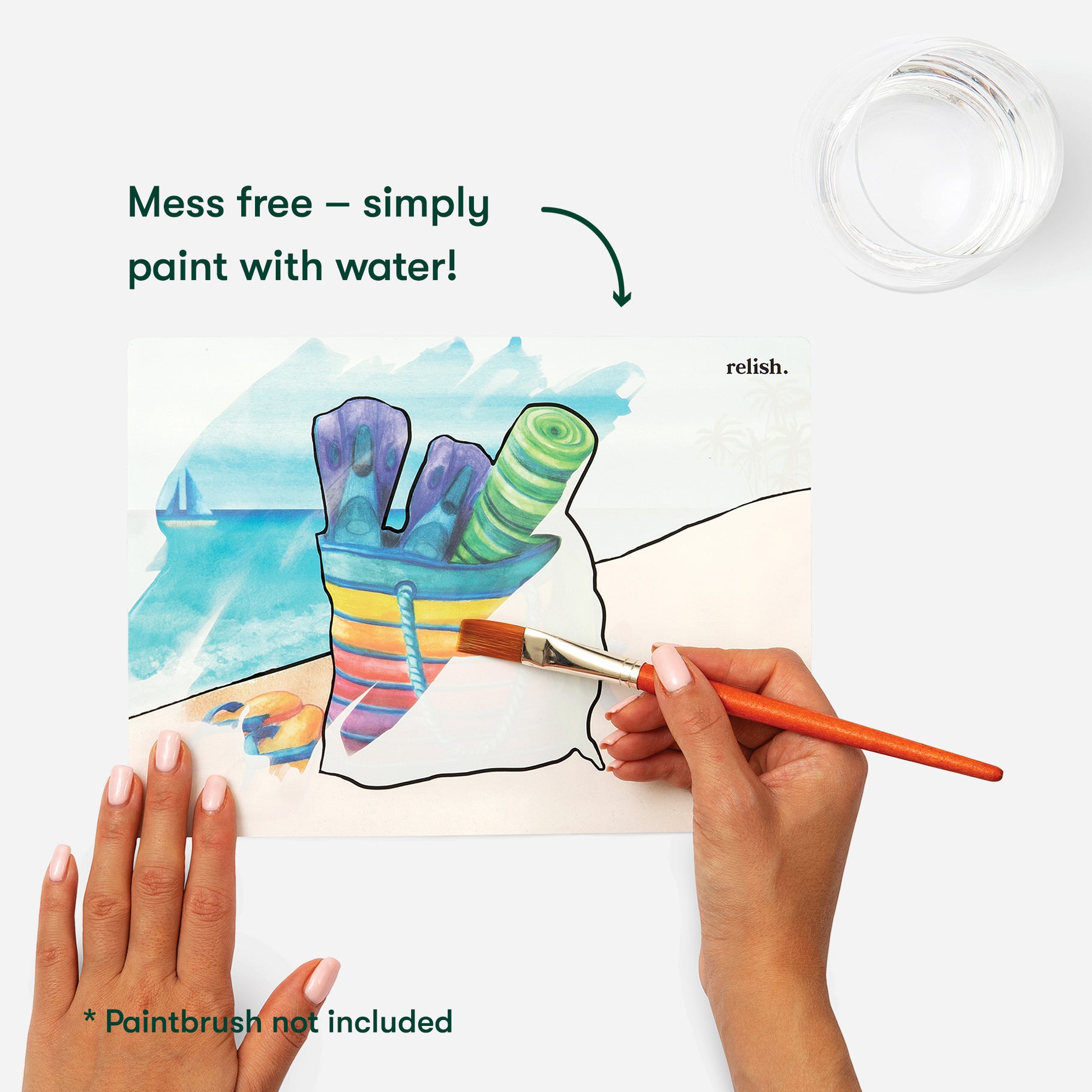 Hands painting a colourful beach scene with water on a Relish product, designed for Alzheimer's and dementia care.