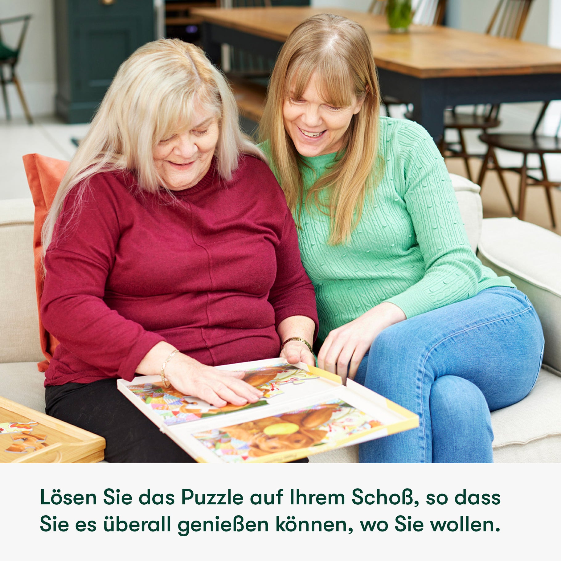 Elderly woman and caregiver enjoy a puzzle, a perfect activity for dementia patients in care homes, fostering connection.