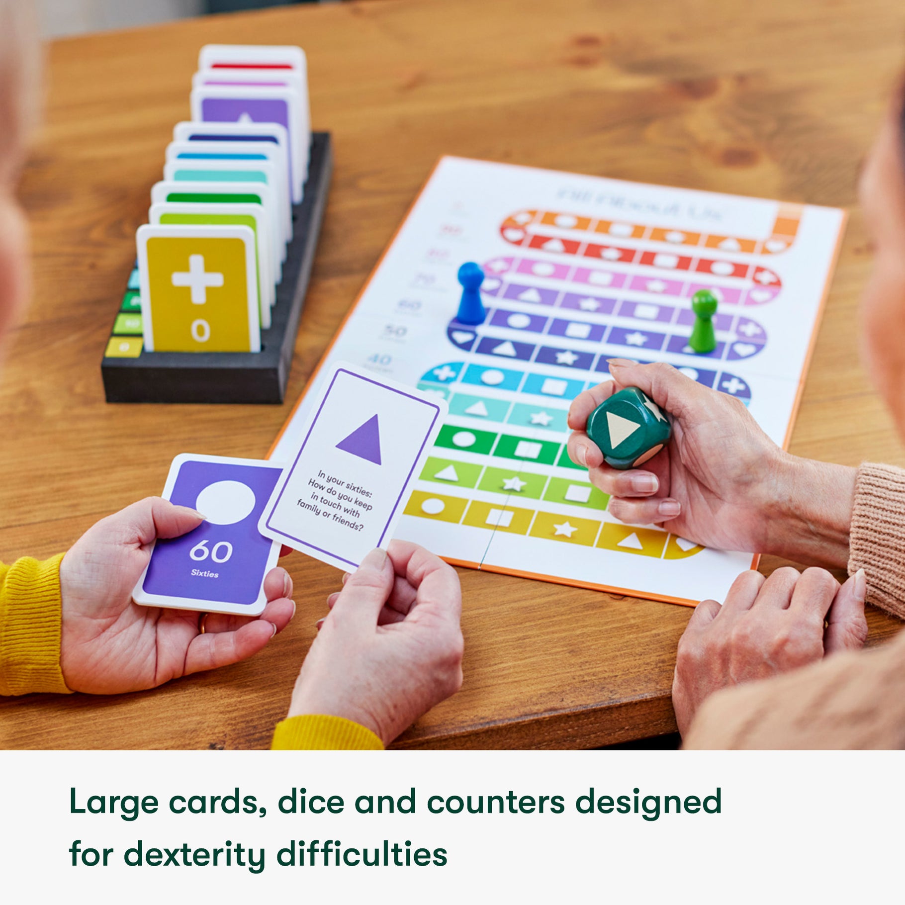 Board game for people living with dementia with large cards, dice, and colorful board, ideal for care home activities and engagement.