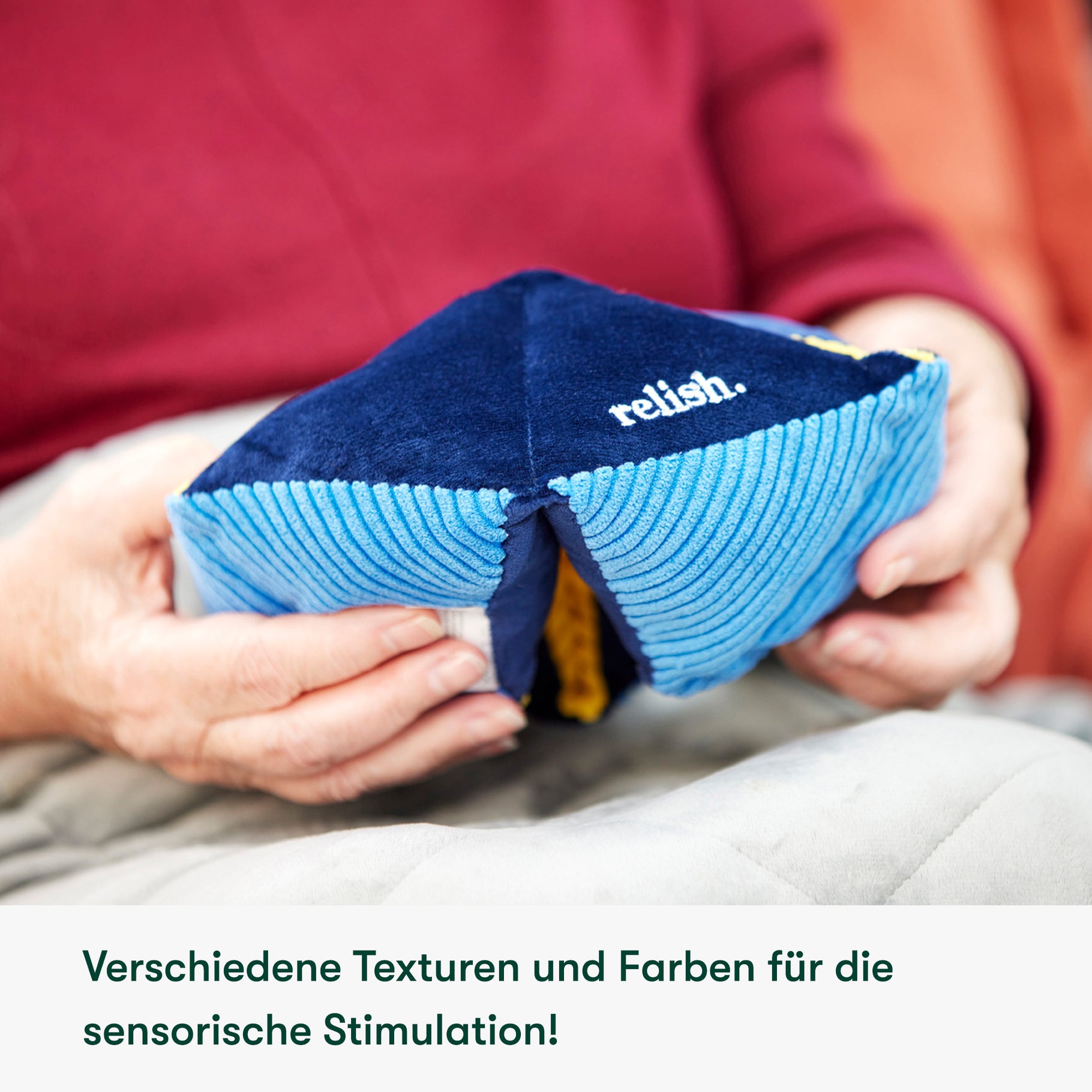 Elderly hands hold a Relish sensory toy, ideal for dementia activities, promoting engagement and sensory stimulation.