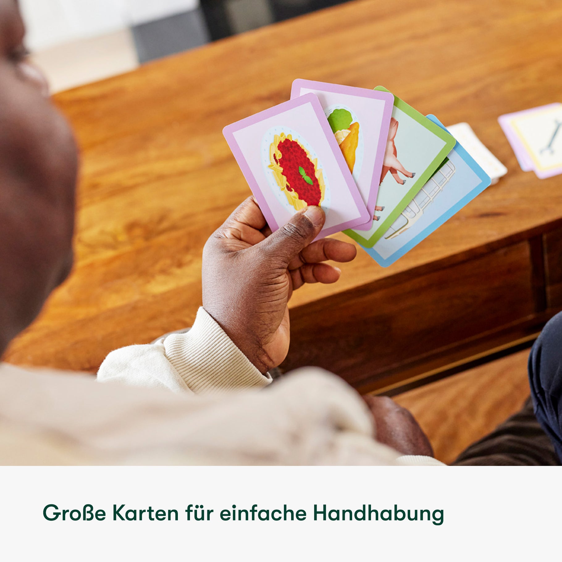 Elderly person holds colorful cards, ideal for dementia activities, care home games, and gifts for people with dementia.