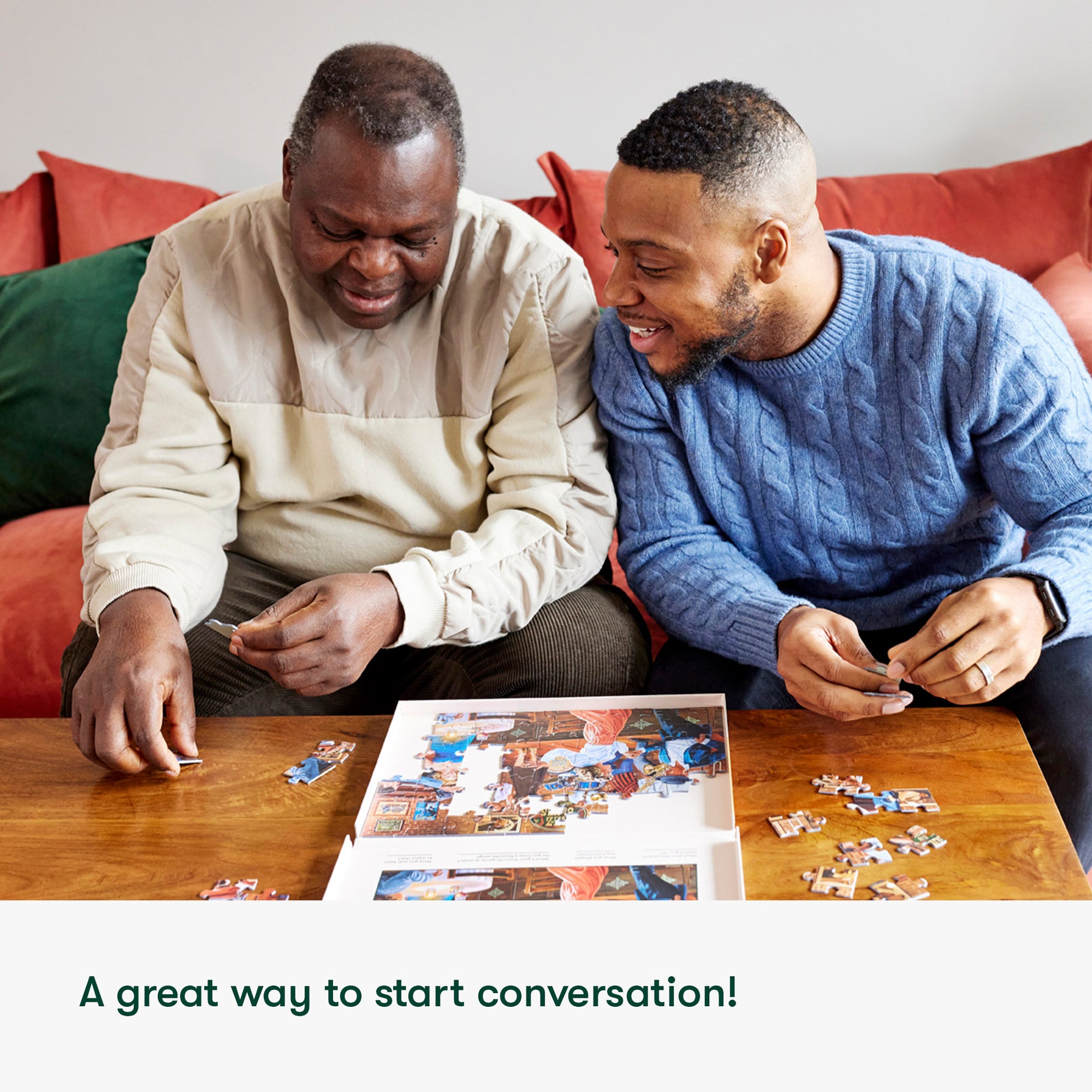 Two men enjoy a puzzle, a perfect activity for dementia patients, promoting connection and joy in care homes.