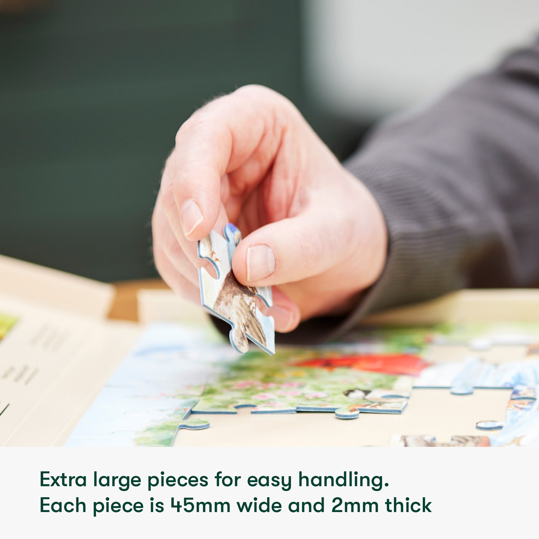 Hand holding a large puzzle piece, ideal for dementia activities and care home residents, promoting engagement and joy.