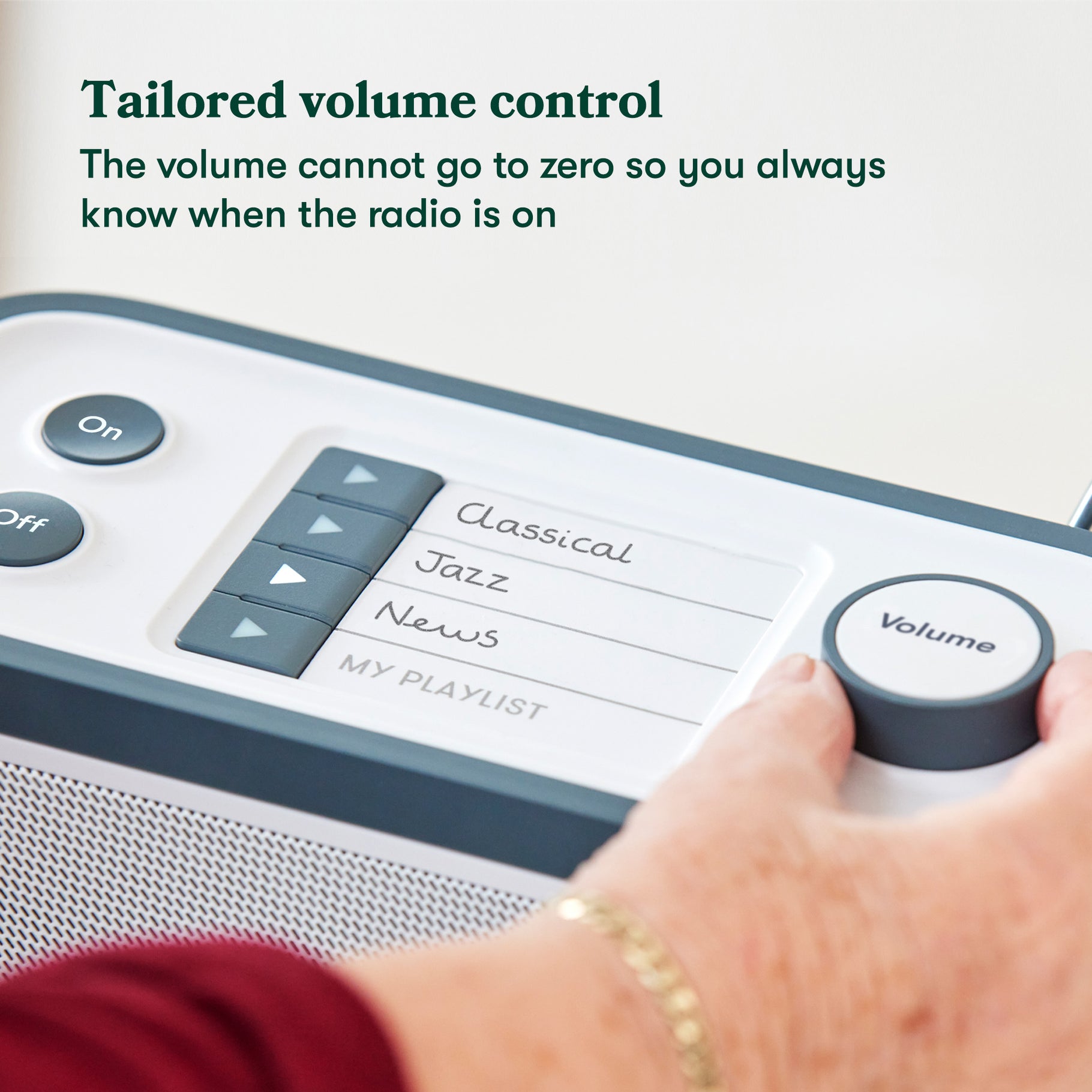 Person turning the volume down on the Radio top panel. Image caption: Tailored volume control
The volume cannot go to zero so you always know when the radio is