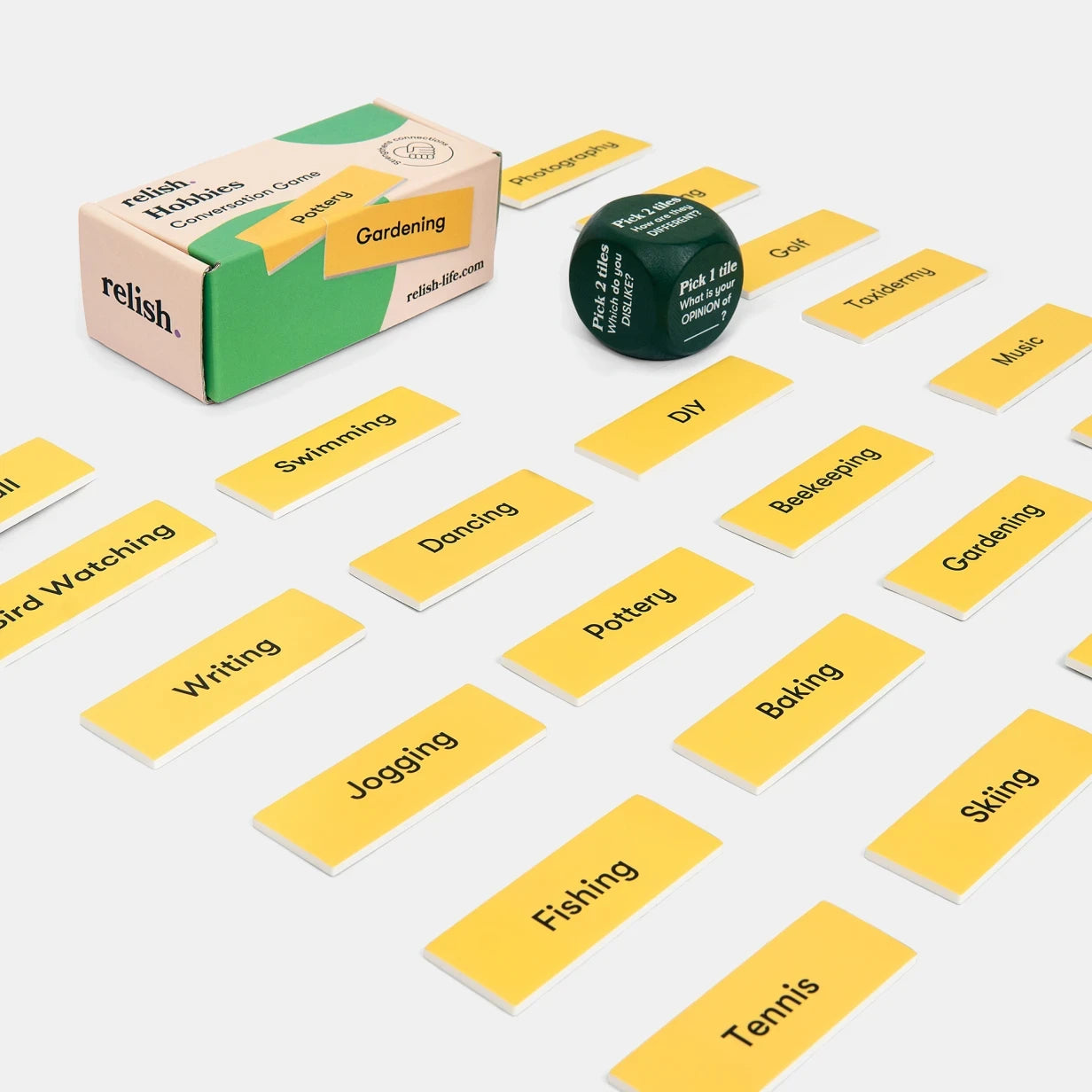 Cards and a dice from a Relish Life game for people living with dementia, featuring activities for care homes and elderly engagement.