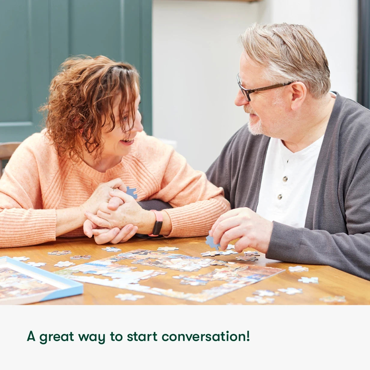 Elderly couple enjoys a puzzle, a perfect activity for people living with dementia in care homes, fostering connection and engagement.