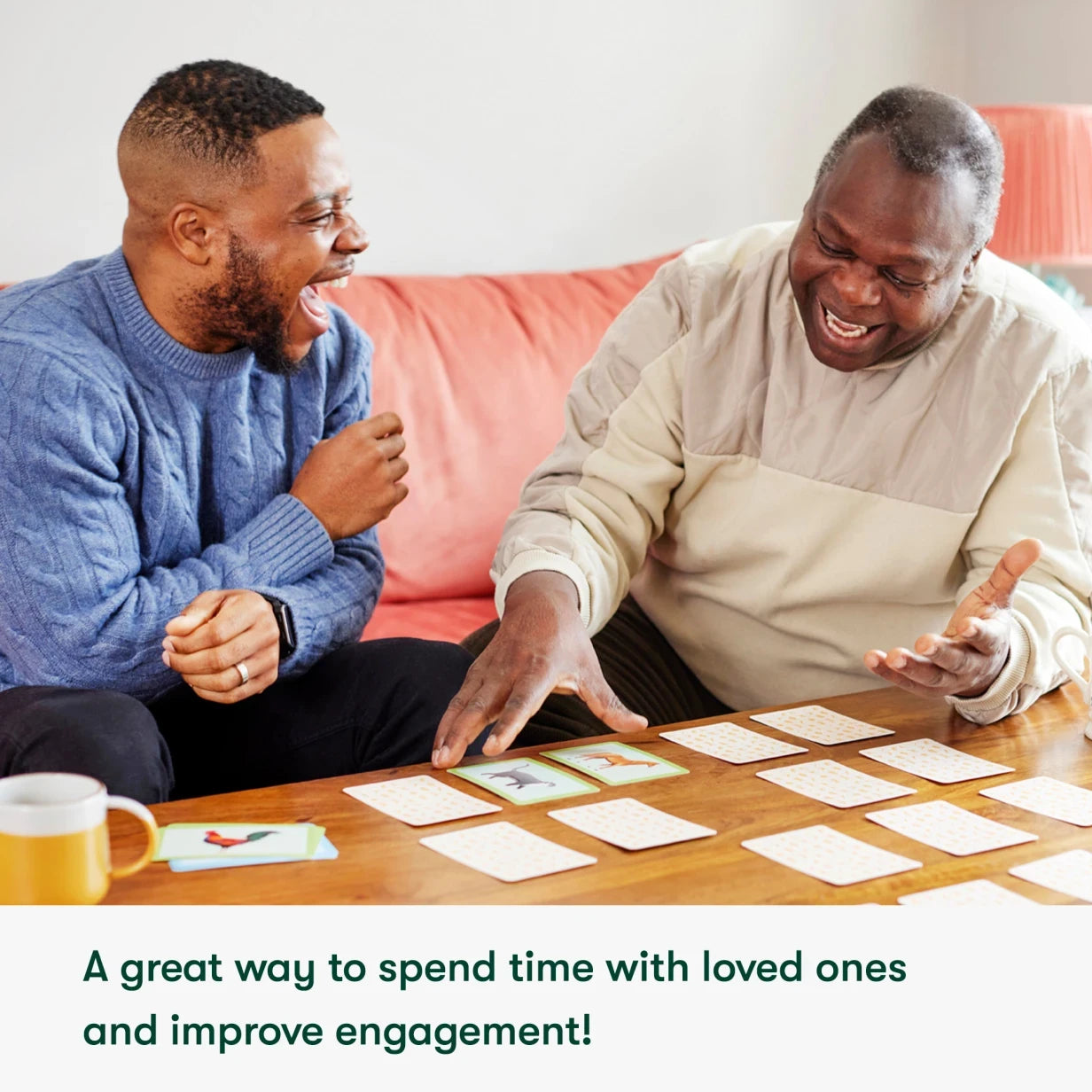 Elderly man and younger man enjoy dementia games, fostering joy and engagement in care home activities for people living with dementia.