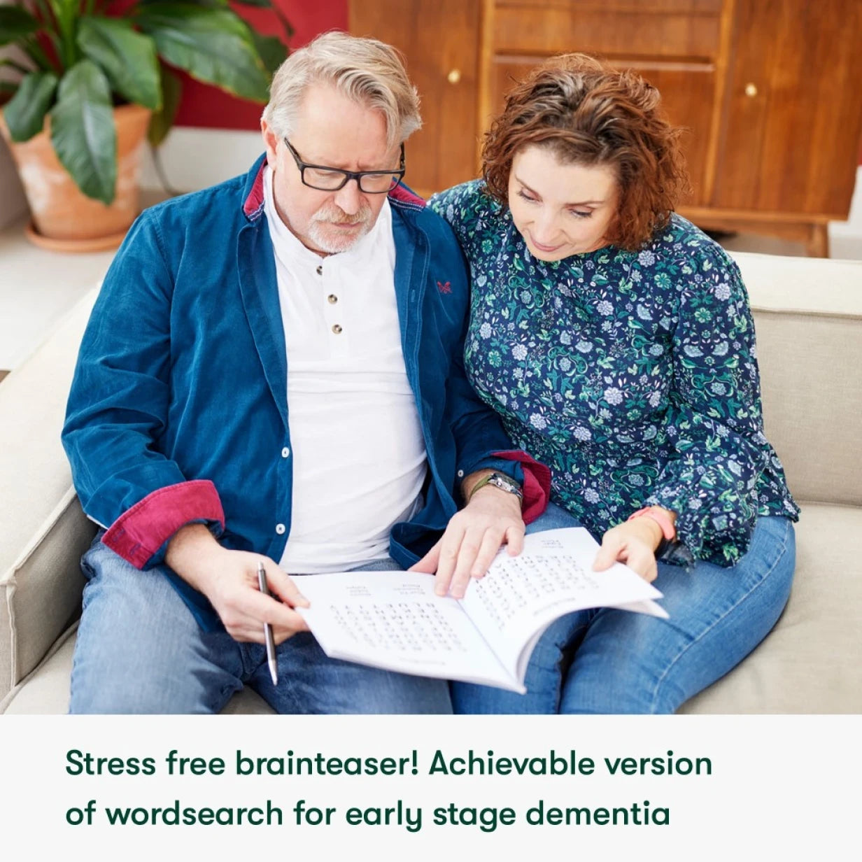 Couple enjoys a dementia-friendly word search, ideal for care home activities, promoting engagement and connection.