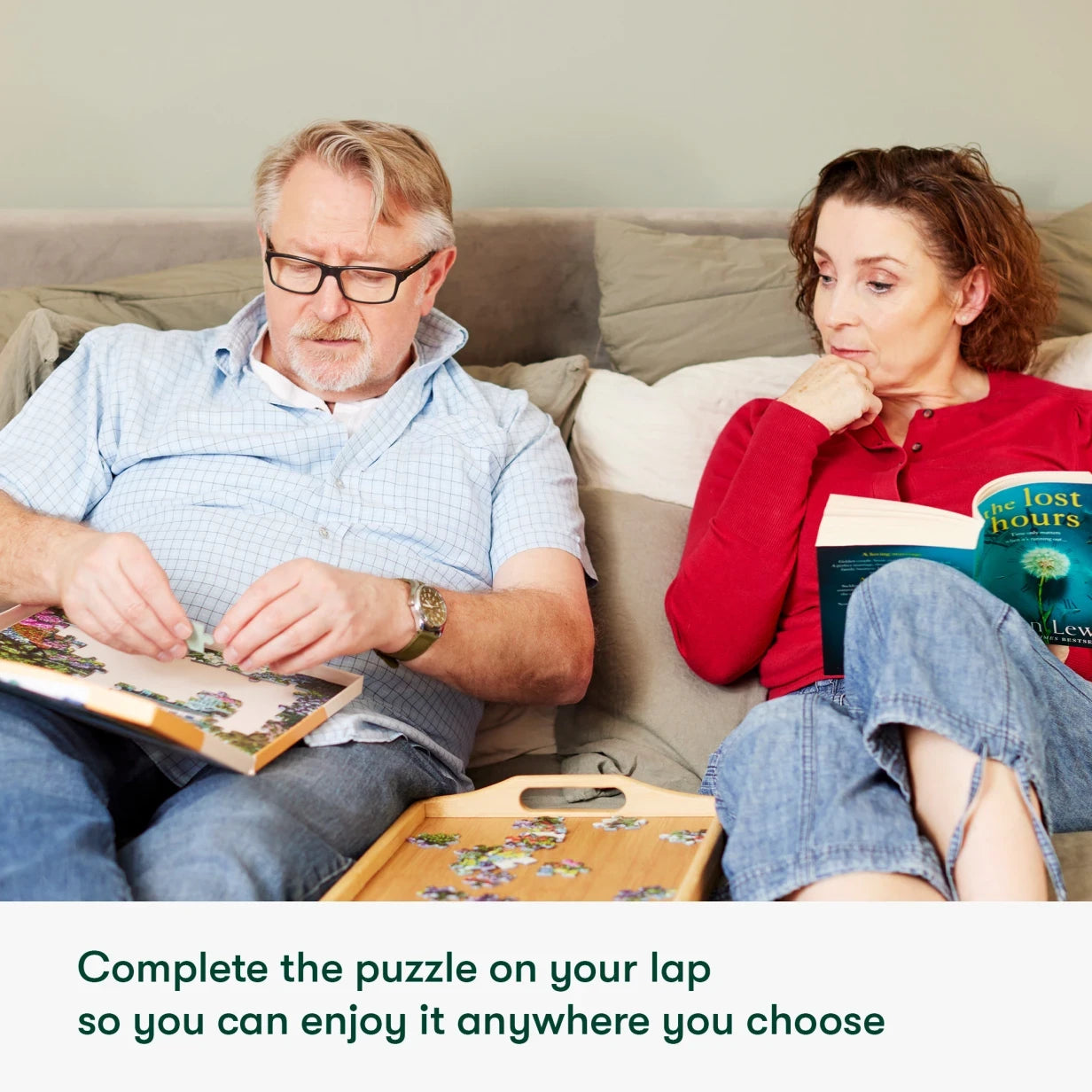 Elderly couple enjoys dementia-friendly jigsaw puzzles, ideal for care home activities and Alzheimer's gifts, on a cozy sofa.