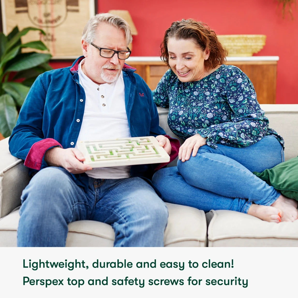 Elderly couple enjoying a dementia-friendly board game, ideal for care home activities and gifts for people with dementia.