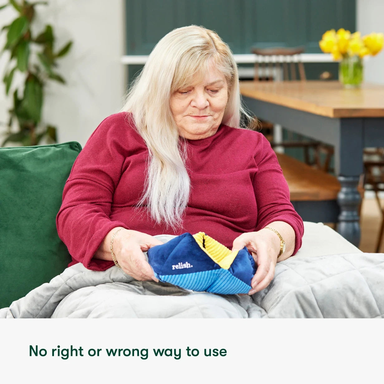 Elderly woman enjoys a Relish Life sensory toy, ideal for dementia activities, promoting engagement and calm in care homes.