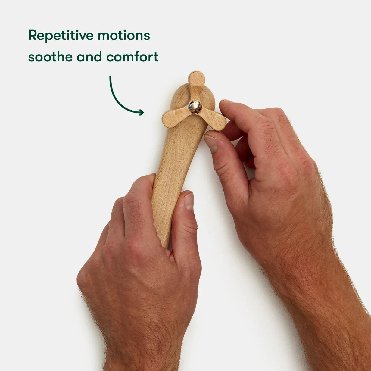 Hands hold a wooden fidget toy, ideal for dementia activities, soothing and comforting for elderly in care homes.