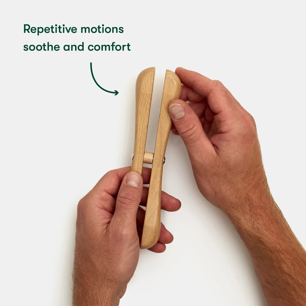 Hands holding a wooden fidget toy for people living with dementia, promoting comfort and engagement in care home activities.