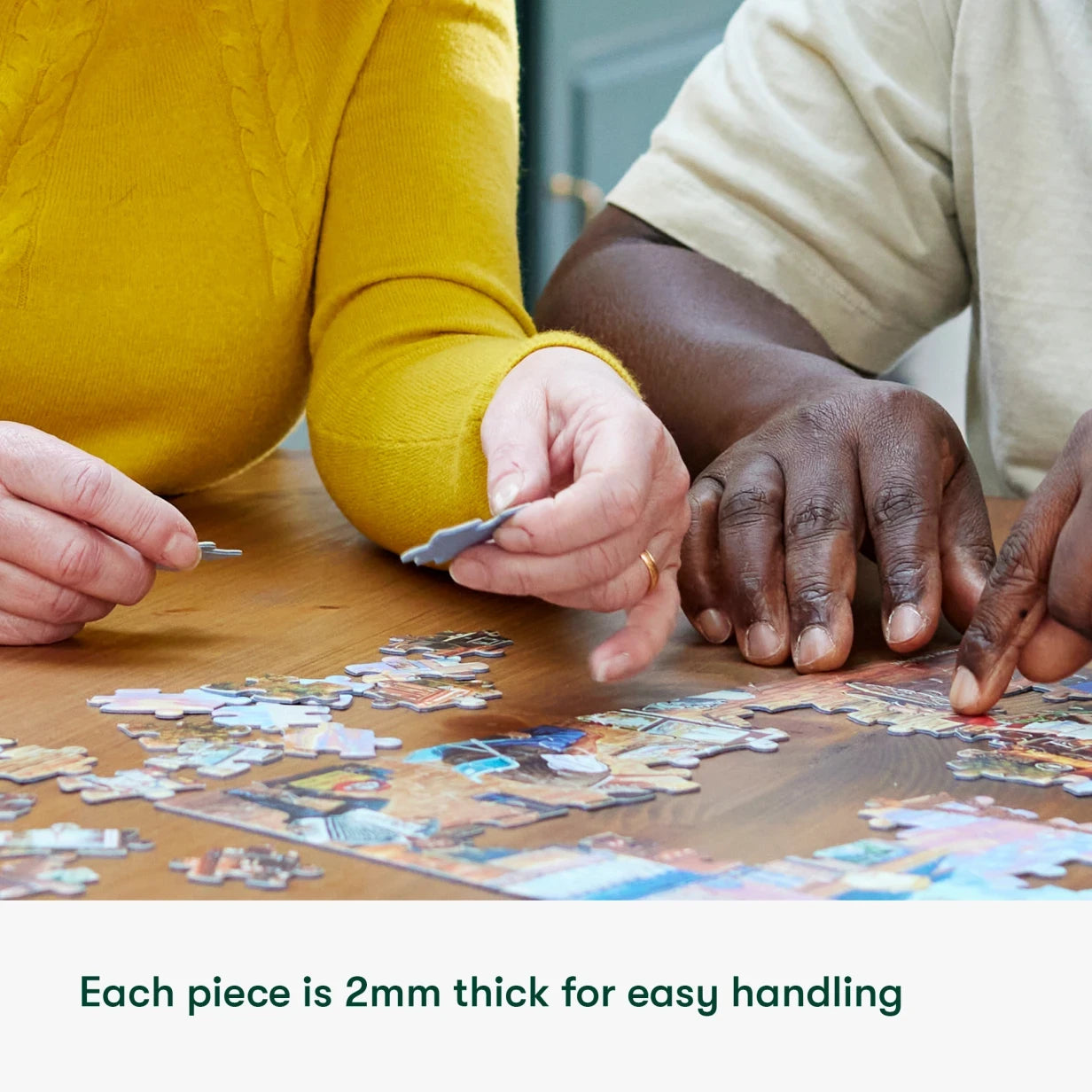 Elderly hands piece together a dementia-friendly jigsaw, ideal for care home activities and gifts for people with dementia.