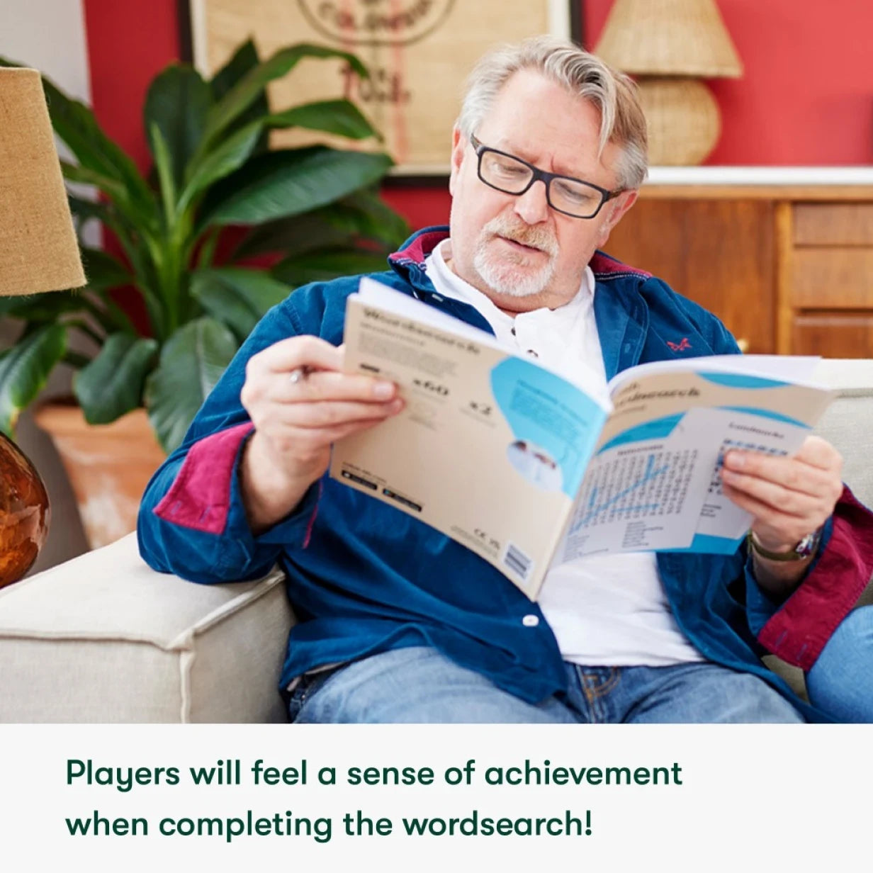 Elderly man enjoys a word search, a great activity for people living with dementia, promoting engagement and cognitive stimulation.