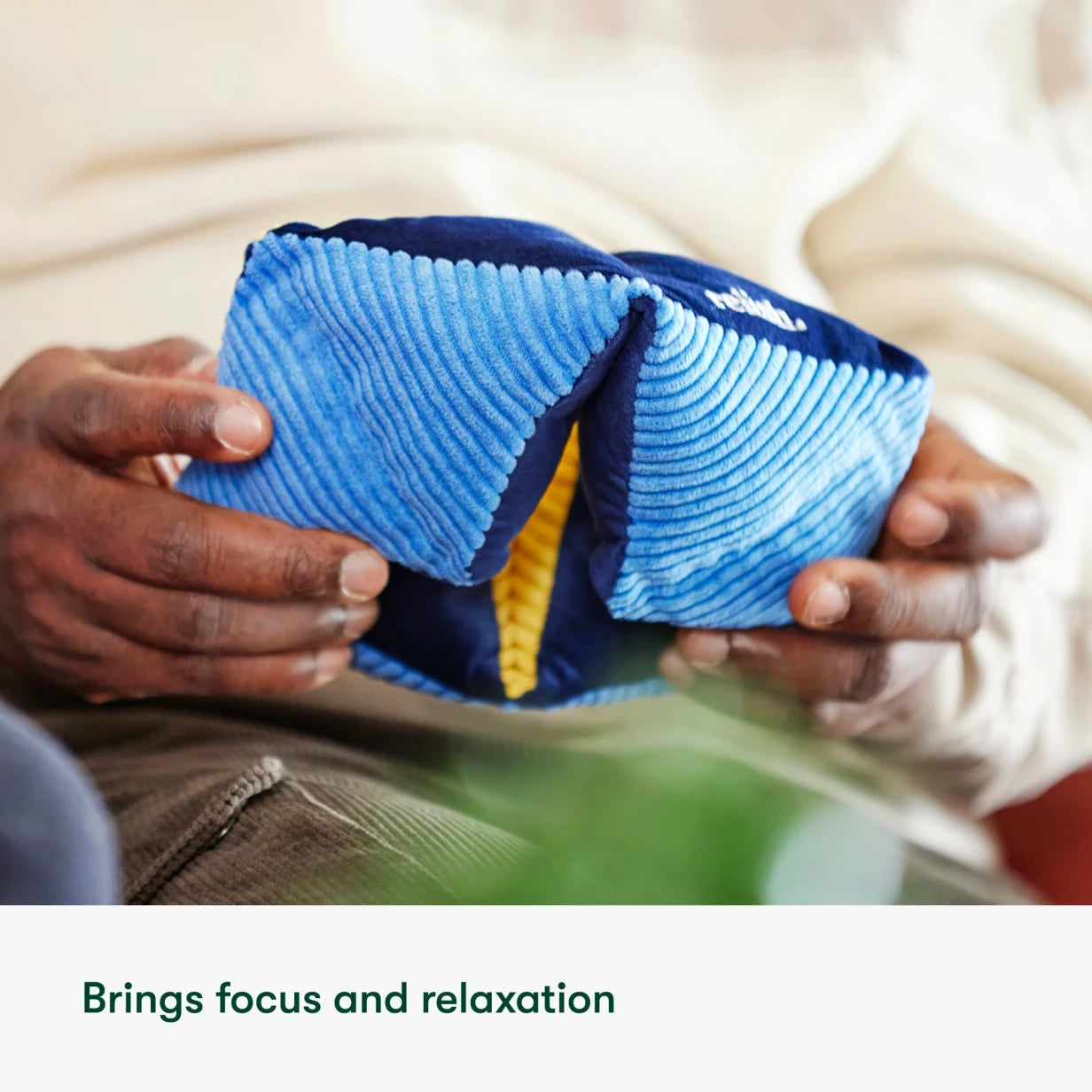 Hands holding a blue sensory toy, ideal for dementia activities, care home activities, and gifts for people with dementia.