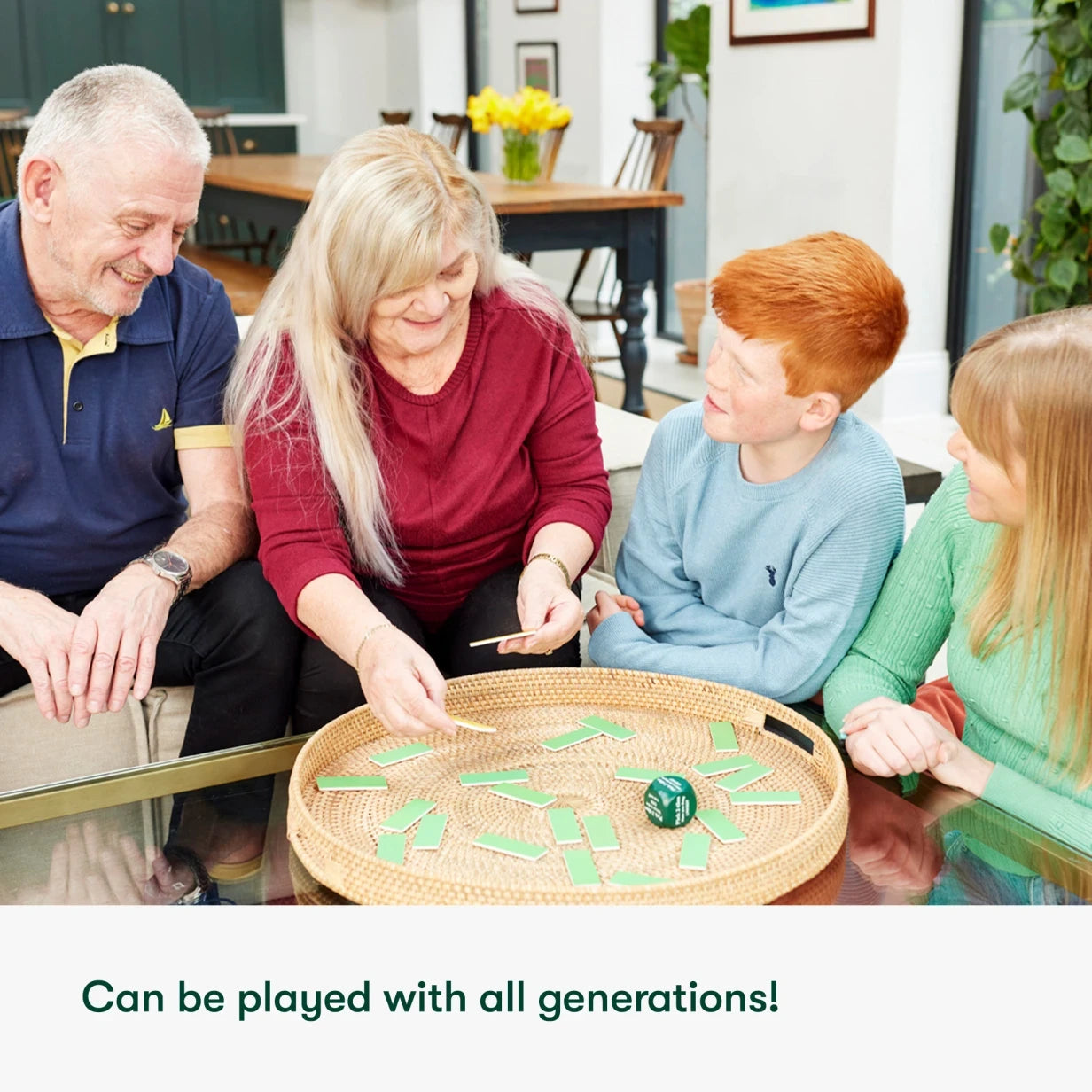 Family playing a board game, ideal for dementia care homes, fostering connection and joy. Perfect for elderly activities.